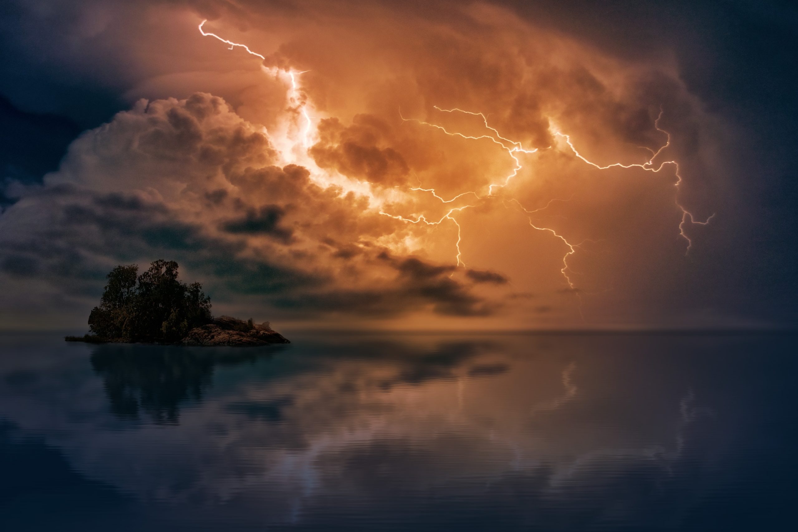 thunderstorm above water near an island