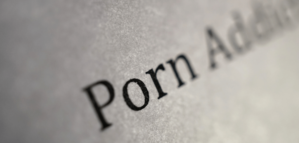 Porn addiction word highlighted on the paper with black font color