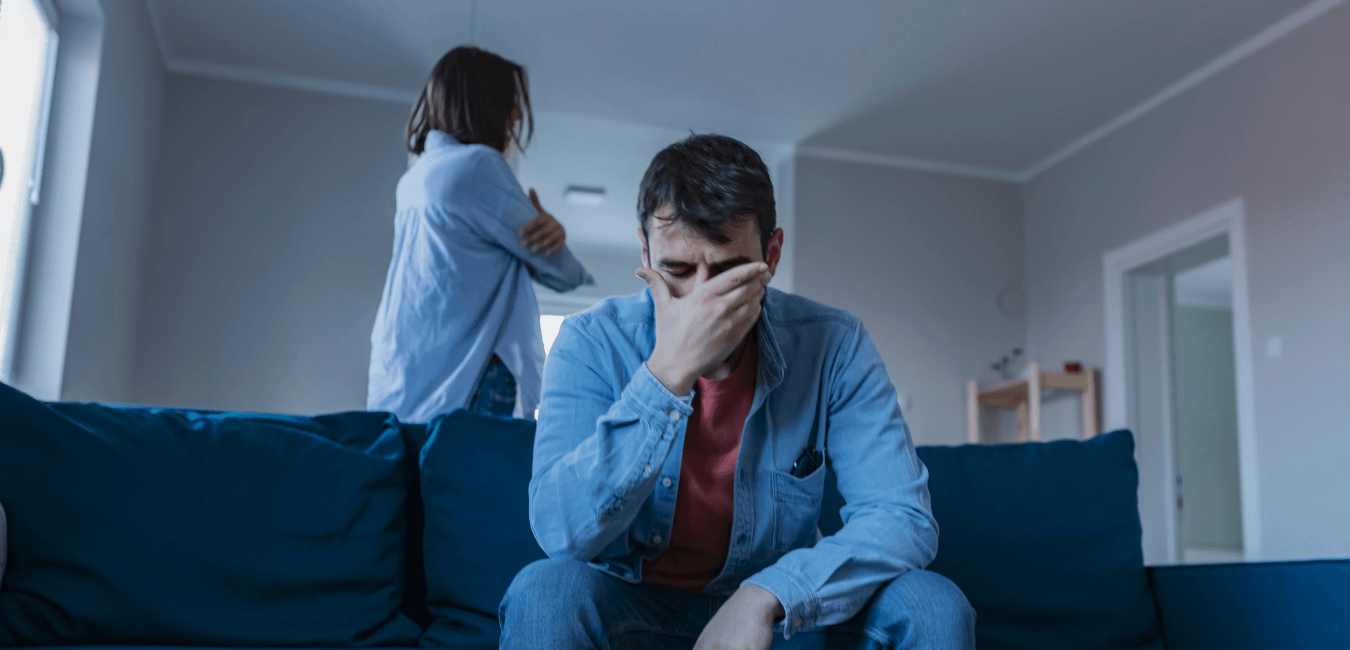 Young couple both wearing denim jacket looking unhappy after quarrelling inside their house