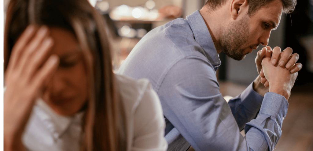 Couple with relationship problems sitting separately on couch ignoring each other
