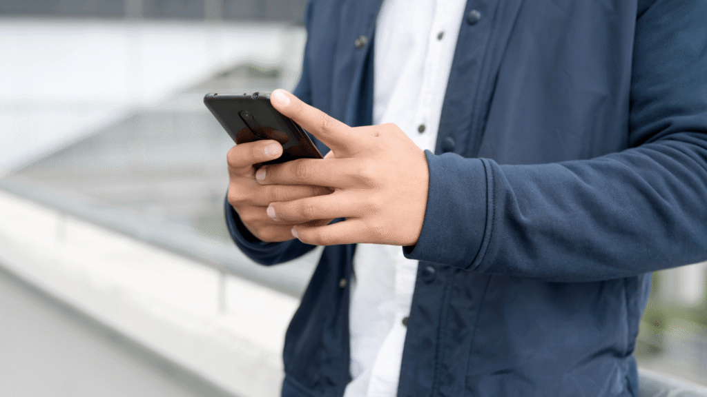 Man chatting online on his phone, shown in a close-up shot