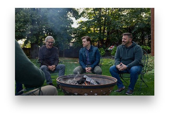 men sitting around a fire